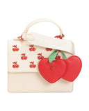 Betsey Johnson Crossbody Bag with Attached Charm, Cream with Red Cherry Studs, Dual Compartment, Adjustable Strap, 8x6 Inch
