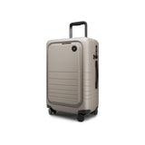 Monos Carry - On Pro Plus Luggage (23"), Hardside Spinner Suitcase with TSA Lock & Front Pocket, Airline Approved, Desert Taupe, Beige