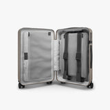 Monos Carry - On Pro Plus Luggage (23"), Hardside Spinner Suitcase with TSA Lock & Front Pocket, Airline Approved, Desert Taupe, Beige