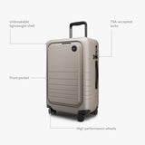 Monos Carry - On Pro Plus Luggage (23"), Hardside Spinner Suitcase with TSA Lock & Front Pocket, Airline Approved, Desert Taupe, Beige