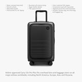 Monos Carry - On Pro Plus Luggage (23"), Hardside Spinner Suitcase with TSA Lock & Front Pocket, Airline Approved, Midnight Black
