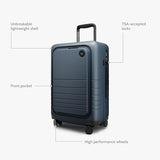 Monos Carry - On Pro Plus Luggage (23"), Hardside Spinner Suitcase with TSA Lock & Front Pocket, Airline Approved, Ocean Blue