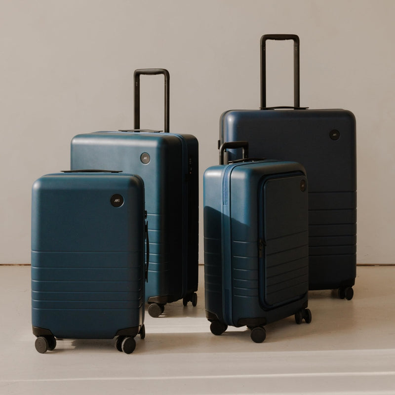 Monos Carry - On Pro Plus Luggage (23"), Hardside Spinner Suitcase with TSA Lock & Front Pocket, Airline Approved, Ocean Blue