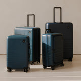 Monos Carry - On Pro Plus Luggage (23"), Hardside Spinner Suitcase with TSA Lock & Front Pocket, Airline Approved, Ocean Blue
