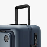 Monos Carry - On Pro Plus Luggage (23"), Hardside Spinner Suitcase with TSA Lock & Front Pocket, Airline Approved, Ocean Blue