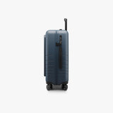 Monos Carry - On Pro Plus Luggage (23"), Hardside Spinner Suitcase with TSA Lock & Front Pocket, Airline Approved, Ocean Blue