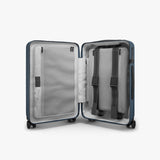 Monos Carry - On Pro Plus Luggage (23"), Hardside Spinner Suitcase with TSA Lock & Front Pocket, Airline Approved, Ocean Blue