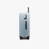 Monos Medium Checked Luggage (26.5"), Lightweight Hardside Spinner Suitcase with TSA Lock, Durable Travel Case, Blue Haze