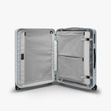 Monos Medium Checked Luggage (26.5"), Lightweight Hardside Spinner Suitcase with TSA Lock, Durable Travel Case, Blue Haze