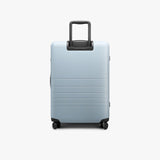 Monos Medium Checked Luggage (26.5"), Lightweight Hardside Spinner Suitcase with TSA Lock, Durable Travel Case, Blue Haze